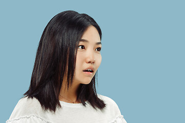 Image showing Korean young woman\'s half-length portrait on blue background