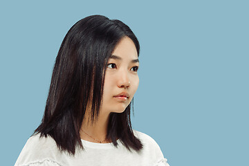 Image showing Korean young woman\'s half-length portrait on blue background