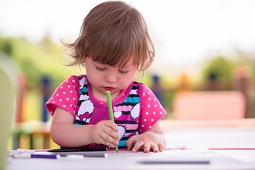 Image showing little girl drawing a colorful pictures