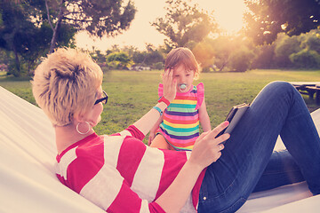 Image showing mom and a little daughter relaxing in a hammock