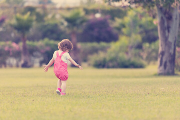 Image showing little girl spending time at backyard