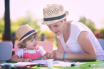 Image showing mom and little daughter drawing a colorful pictures