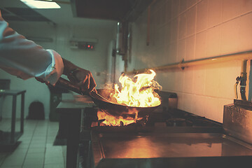 Image showing Chef doing flambe on food