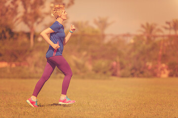 Image showing young female runner training for marathon