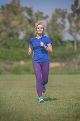 Image showing young female runner training for marathon