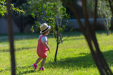 Image showing little girl runing in the summer Park