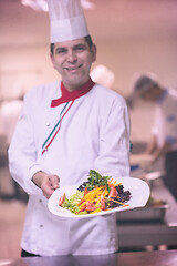 Image showing Chef showing a plate of tasty meal