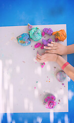 Image showing kid hands Playing with Colorful Clay