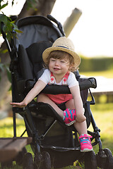 Image showing baby girl sitting in the baby stroller