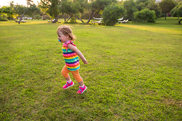 Image showing little girl spending time at backyard