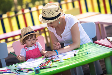 Image showing mom and little daughter drawing a colorful pictures