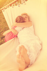 Image showing mother and a little daughter relaxing in a hammock