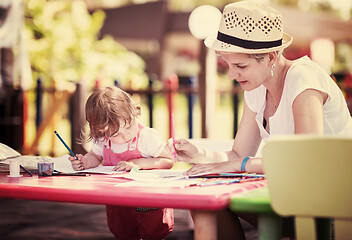 Image showing mom and little daughter drawing a colorful pictures