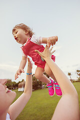 Image showing mother and little daughter playing at backyard