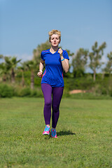 Image showing young female runner training for marathon