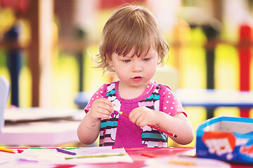 Image showing little girl drawing a colorful pictures