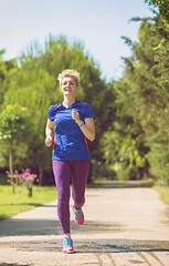 Image showing young female runner training for marathon