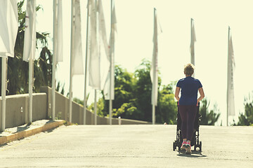 Image showing mom with baby stroller jogging