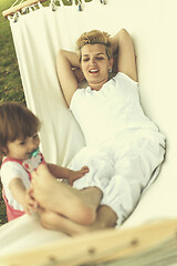 Image showing mother and a little daughter relaxing in a hammock