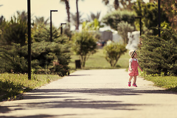 Image showing little girl runing in the summer Park