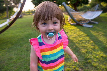 Image showing little girl spending time at backyard