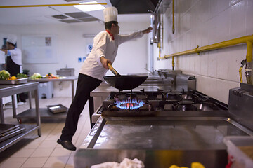 Image showing chef preparing food, frying in wok pan