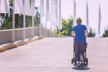 Image showing mom with baby stroller jogging