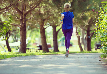 Image showing young female runner training for marathon