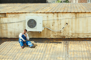 Image showing HVAC technician working on a capacitor part for condensing unit