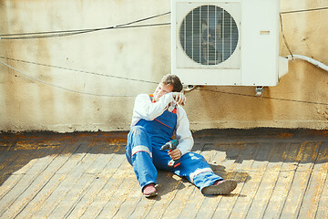 Image showing HVAC technician working on a capacitor part for condensing unit