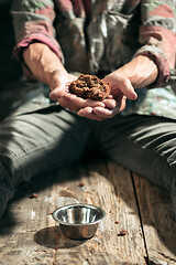 Image showing Male beggar hands seeking food or money at public path way