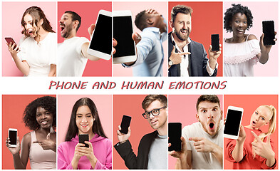 Image showing Portrait of people showing screen of mobile phone isolated over coral background