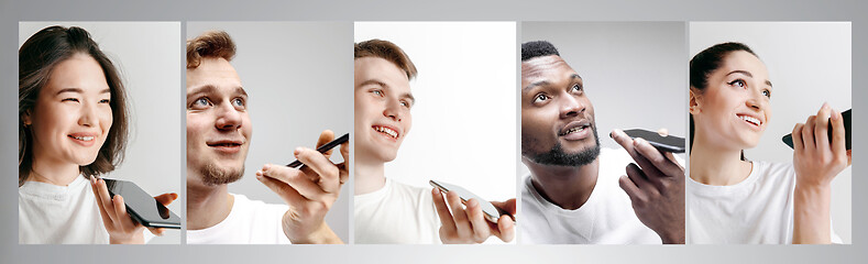 Image showing Portrait of people showing blank screen mobile phone isolated over white background