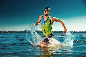 Image showing Professional triathlete swimming in river\'s open water