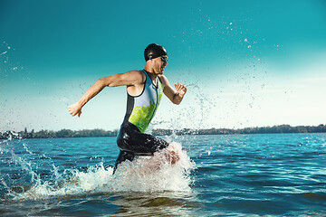 Image showing Professional triathlete swimming in river\'s open water