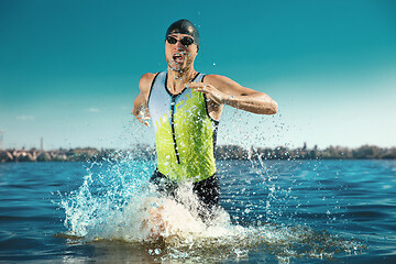 Image showing Professional triathlete swimming in river\'s open water