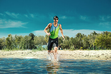 Image showing Professional triathlete swimming in river\'s open water