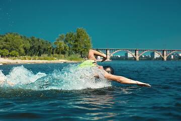 Image showing Professional triathlete swimming in river\'s open water