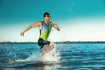 Image showing Professional triathlete swimming in river\'s open water