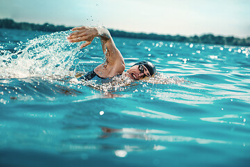 Image showing Professional triathlete swimming in river\'s open water