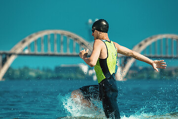 Image showing Professional triathlete swimming in river\'s open water