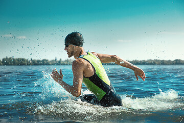 Image showing Professional triathlete swimming in river\'s open water