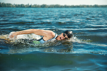 Image showing Professional triathlete swimming in river\'s open water