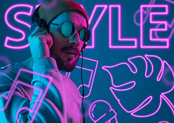 Image showing Beautiful young man isolated on studio background in neon light