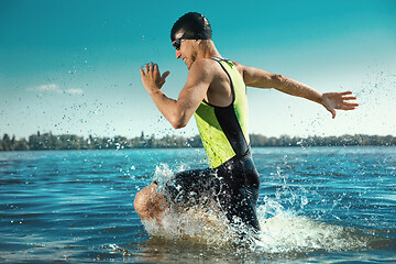 Image showing Professional triathlete swimming in river\'s open water