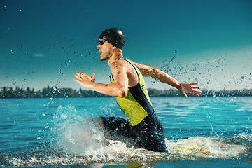 Image showing Professional triathlete swimming in river\'s open water