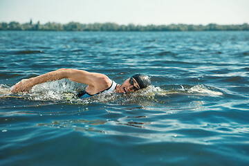 Image showing Professional triathlete swimming in river\'s open water