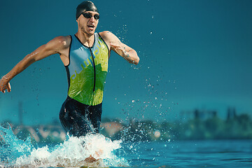 Image showing Professional triathlete swimming in river\'s open water