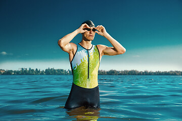 Image showing Professional triathlete swimming in river\'s open water