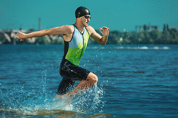 Image showing Professional triathlete swimming in river\'s open water